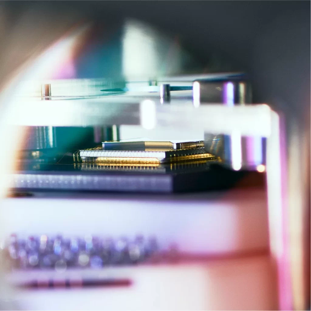 Close-up of semiconductor chips with a futuristic, colorful glow, illustrating advanced technology in quantum computing.
