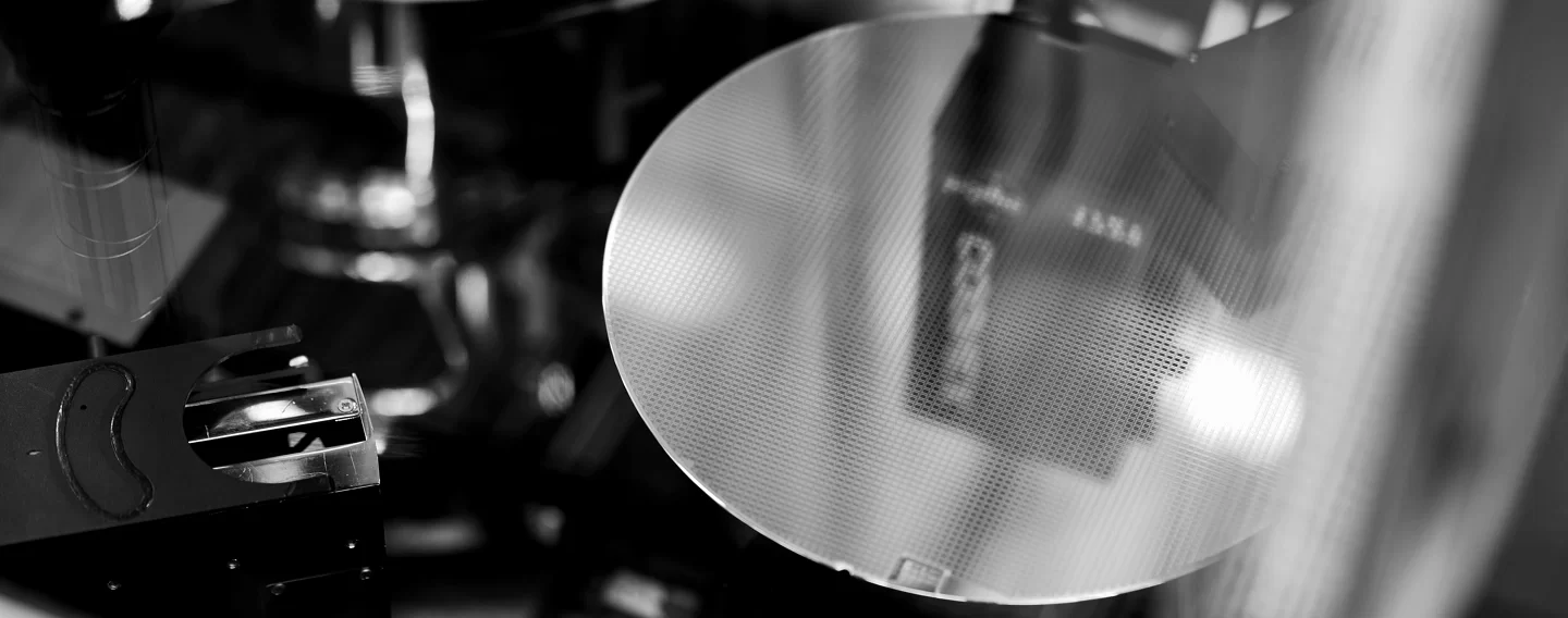 Silicon wafer in a semiconductor fabrication facility, reflecting equipment used in chip manufacturing.