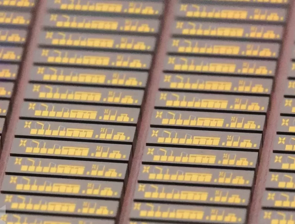 Close-up of semiconductor chips with intricate gold patterns, highlighting SkyWater Technology's role in quantum computing hardware.
