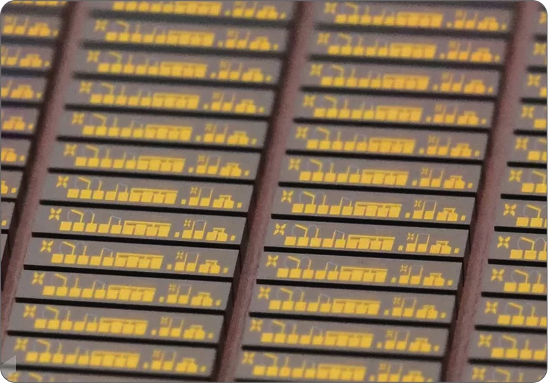 Close-up of semiconductor wafers with intricate circuit patterns, highlighting SkyWater Technology's role in U.S. chip manufacturing.