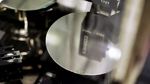 Silicon wafer in a semiconductor fabrication facility, reflecting machinery used in chip production.